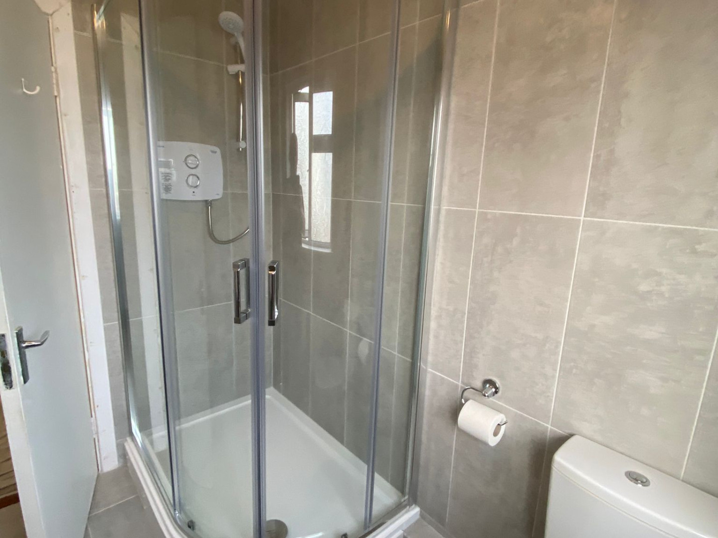 Shower unit with floor to ceiling tiling installed by Elite Building Services Swords